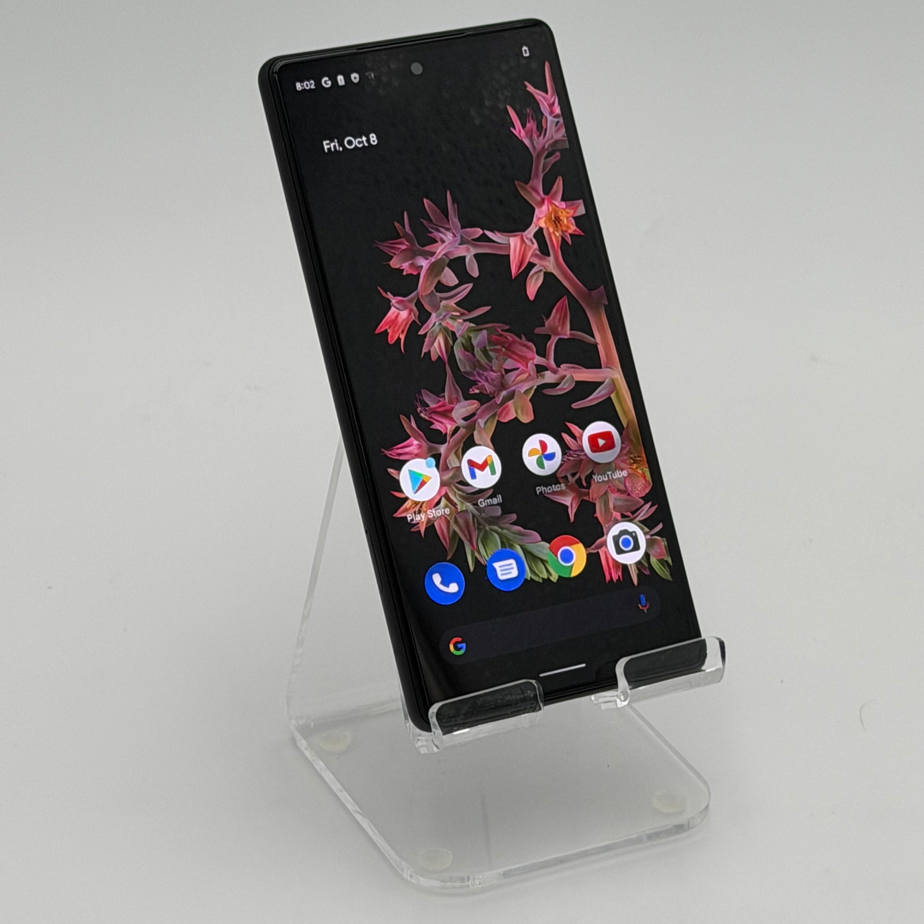 Google pixel 6 Smartphone on a clear stand with a white background